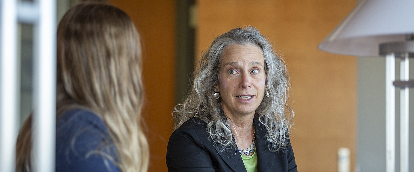 Professor Roberta Mann speaking with a student