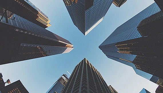 Looking up at skyscraper buildings.