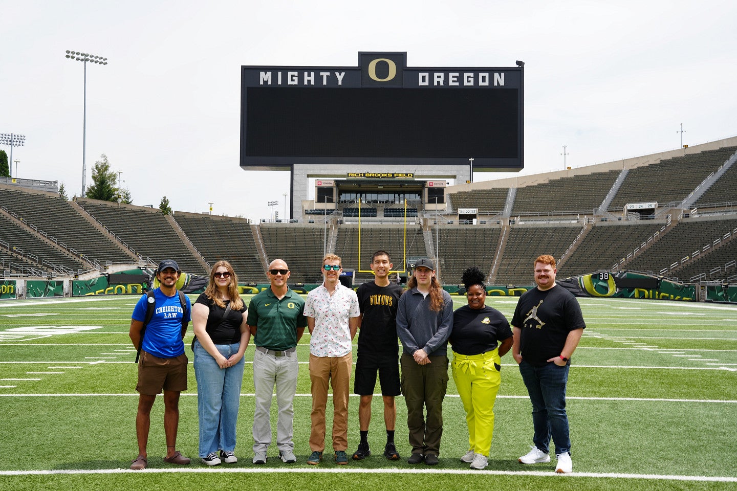 Students on the turf at Autzen stadium
