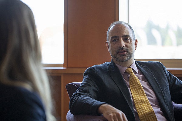 Professor Eric Priest sitting down and talking with a law student