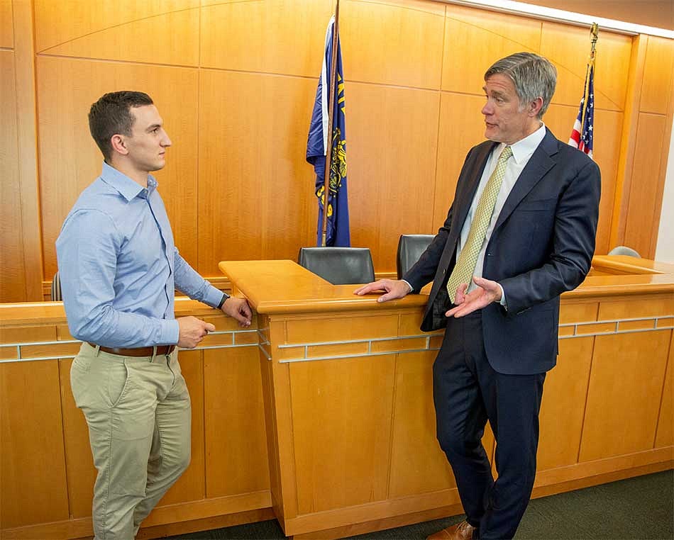 Two men having a conversation in a courtroom