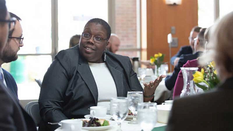 Adrienne Nelson speaking to students at a banquet table