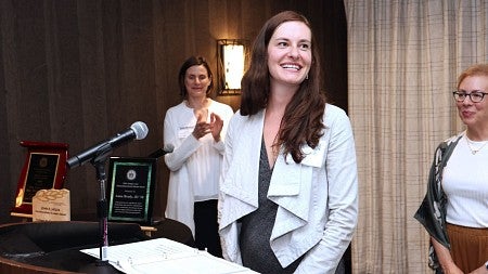 Anna Brady is applauded as she receives Oregon Law's Outstanding Recent Alumni Award at the Alumni & Friends Fall Celebration in September 2024