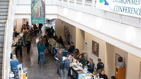 Attendees browse tables at the PIELC conference.