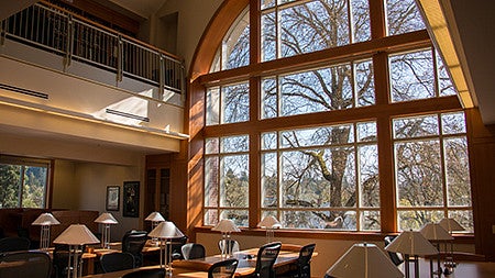 3rd floor law library large window with sunlight on study desks