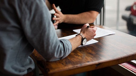 Two people at a table talking