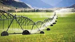 An irrigation pivot sprays water on a field