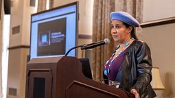 Dr. Reyes-Santos speaks at a podium (photo from Oklahoma State University)