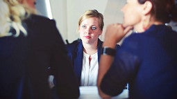 business woman sitting at a conference table