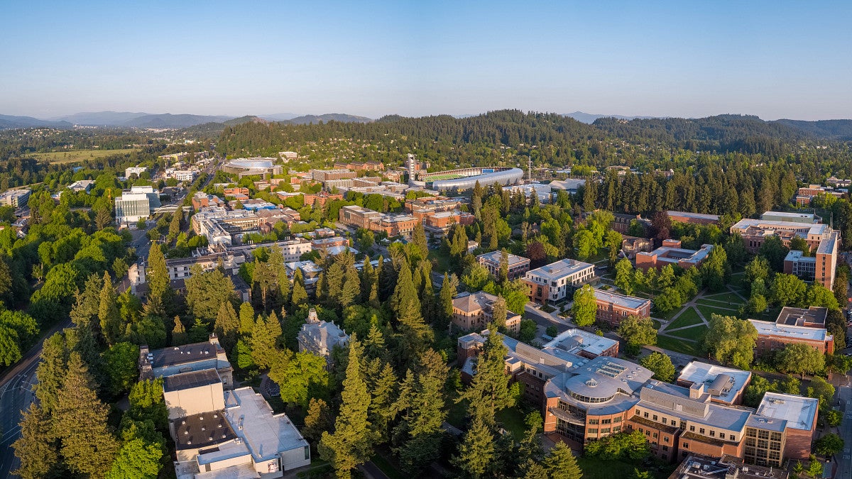 Springtime aerial view of the University of Oregon campus in Eugene, including the Knight Law Center in the middle distance adjacent to Hayward Field.