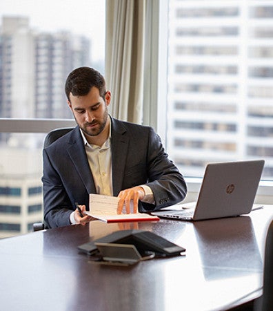 Balasz Takacs at a conference table looking at notes