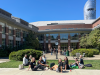 Students socializing outdoors behind the Knight Law Center.