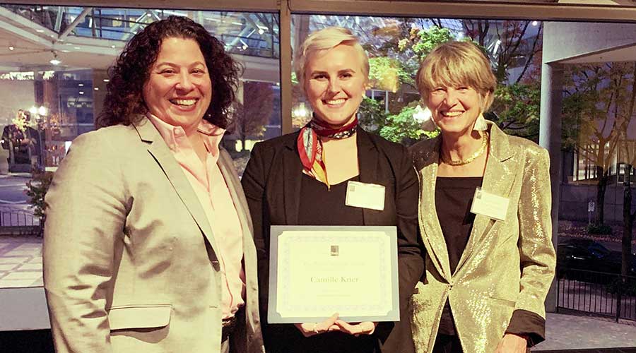 Camille Krier holding her award with Chief Justice Martha Walters and Oregon State Bar President Christine R. Constantino