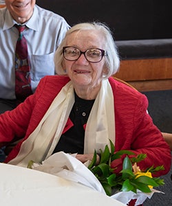 Mary Lawrence holding flowers in 2018 at the LRW conference