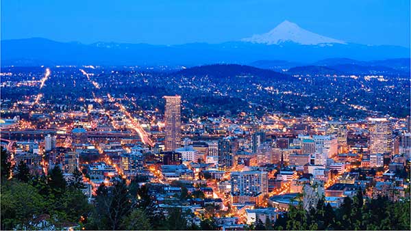Skyline of Portland at dusk with a snow covered Mt Hood in the back ground