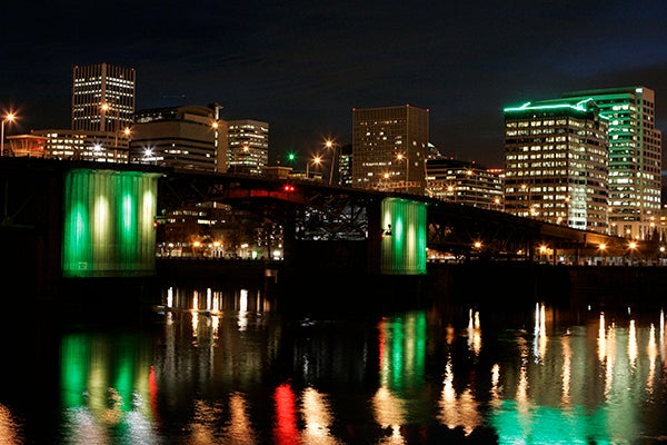 Portland bridge at night with lights reflecting on the river