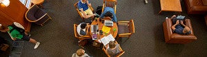 Overhead view of a table with students in the Knight Law Center building
