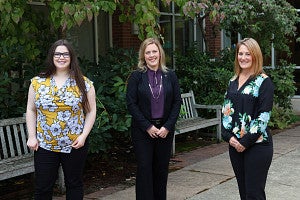Left to right: Echo M, Jessica M, and Rachel K from development standing the the law school courtyard