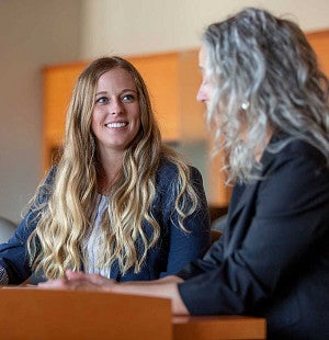 Frohnmayer Leadership Program Two women speaking to each other at a table