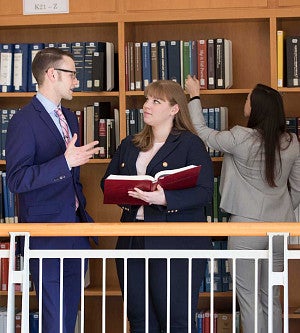 Jaqua Law Library Students in the law library looking over a book