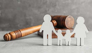 Family paper figures and gavel on table