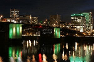 Portland bridge at night with lights reflecting on the river