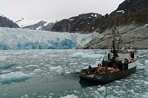Researchers in a boat in front of Alaska’s LeConte Glacier