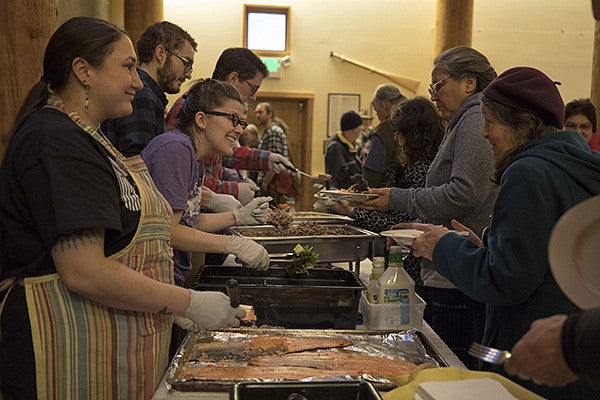 People waiting in a line to be served food a the PIELC 2018