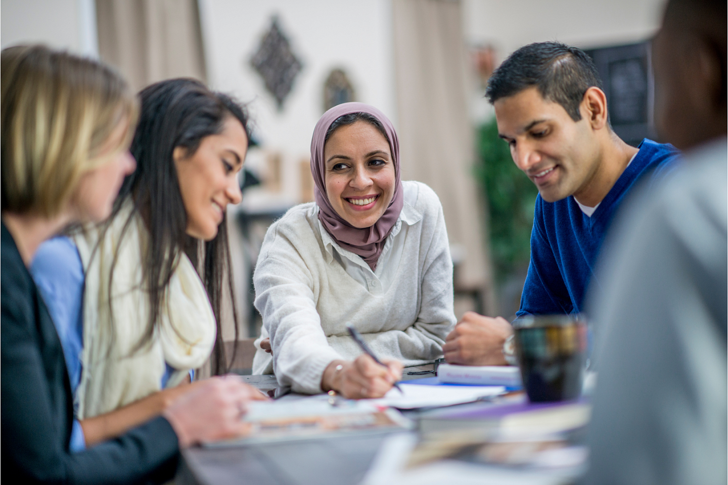 Diverse people sitting around a table and working together