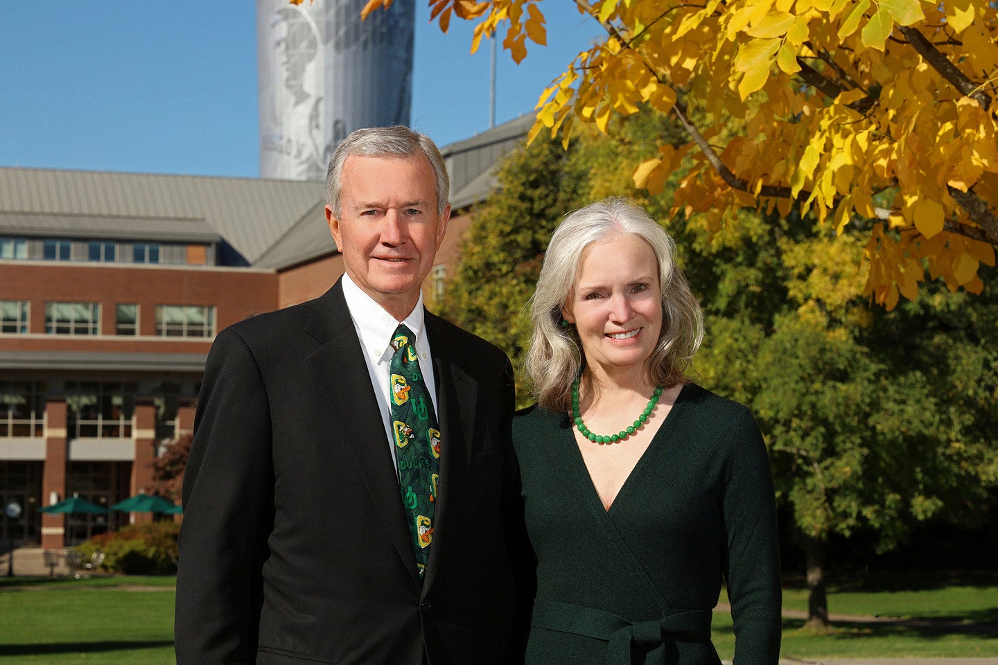 Ron and Linda Greenman in front of the back courtyard of the Knight Law Center