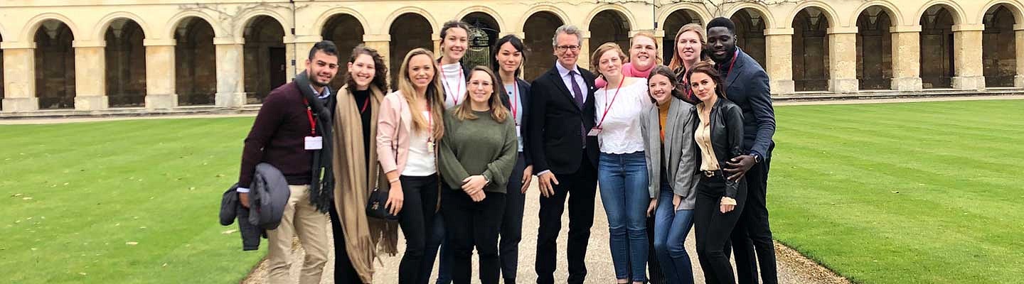 Raymund Fellows at Oxford University. Former conflict and dispute resolution faculty member Cheyney Ryan (center) helped develop the program with support from the Clark Honors College and the law school. A group of Raymund Fellows at Oxford University