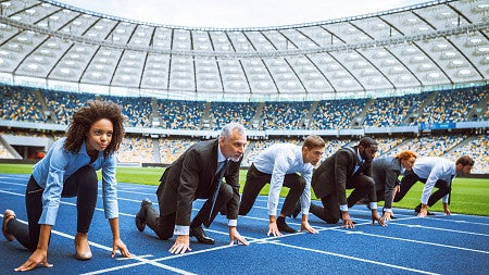 Diverse business people lining up at the starting line on a track field