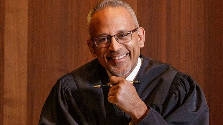 A picture of Judge Mustafa T. Kasubhai in the courtroom.