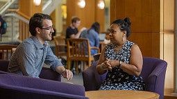 Professor McKinley and a student chatting in the commons