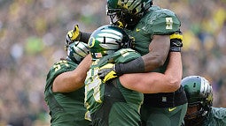 Ducks football team members celebrating