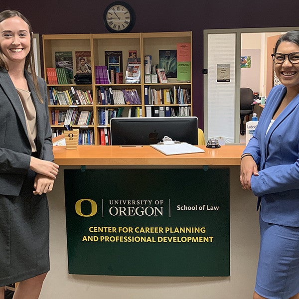 Bailey and Rachelle standing on front of the career center sign smiling