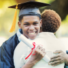 Son smiling at graduation and hugging his mom